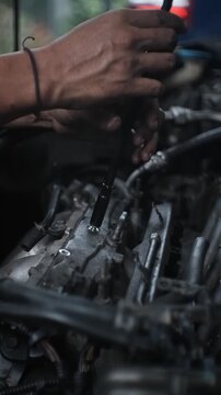 car mechanic changing car engine