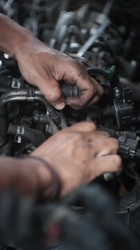 car mechanic changing car engine