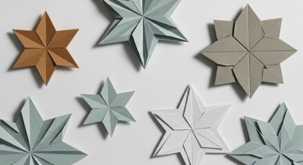 Obraz premium Decorative Paper Stars for Holiday and Festive Decorations in Neutral and Metallic Tones