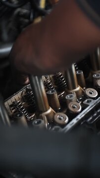 car mechanic changing car engine