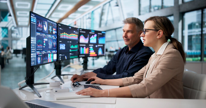 Financial Analyst And Colleague Monitor Business Data Dashboard