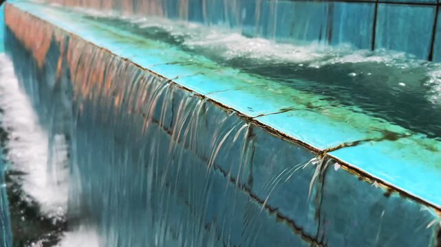 Decorative Water Cascade Feature with Blue Tiled Wall in Urban Setting