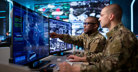 Two Soldiers Use Advanced Computers