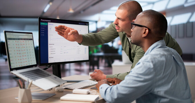 Procurement Manager And Colleague Analyze Software Platform