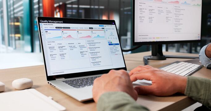 Two Young Men Use QMS Software For Quality Control