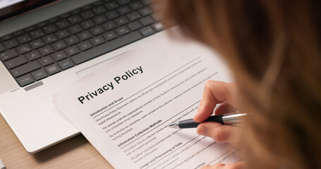 Woman Reading And Signing Important Privacy Policy Documents