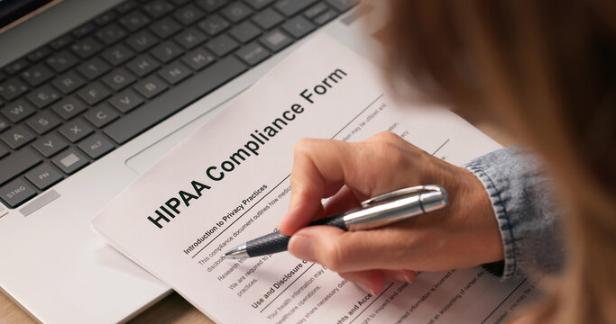 Woman Reviewing Healthcare Documents To Ensure Patient Privacy