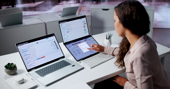 Woman Auditor Uses Laptop To Review Quality Data