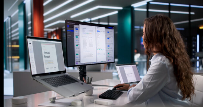 Young Female Office Manager Organizes Digital Files On Laptop