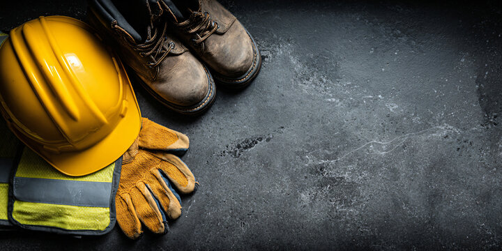 Yellow Hard Hat Gloves and Boots Safety Gear Flatlay