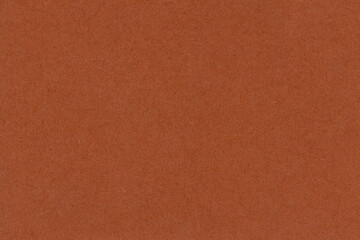 Fototapeta premium Orange brown paper texture with a smooth finish and natural appearance. Versatile background ideal for graphic design, packaging and creative projects.