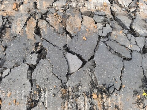 Close up texture of asphalt road surface broken for repair and resurfacing.