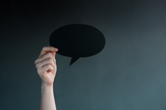 Holding blank speech bubble in dark , Social pressure, emotional expression, mental health