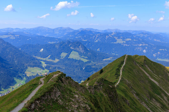 Mountain panorama with hiker hiking over the ridge Fellhorngrat and valley Kleinwalsertal in Allg&auml;u Alps, Austria