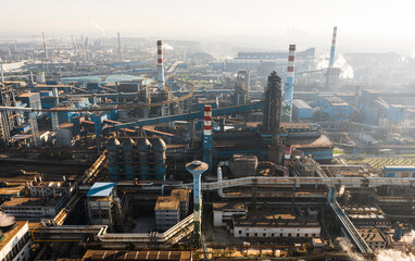 Obraz premium Aerial view of Wuhan steel plant, featuring a complex geometry of massive blast furnaces and intricate pipelines. It reflects China's industry and economy evolution, producing silicon steel for electr