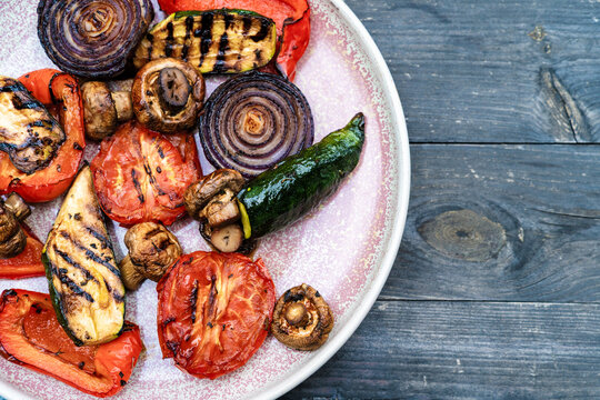 High angle view of delicious grilled vegetables on a plate over rustic wooden table