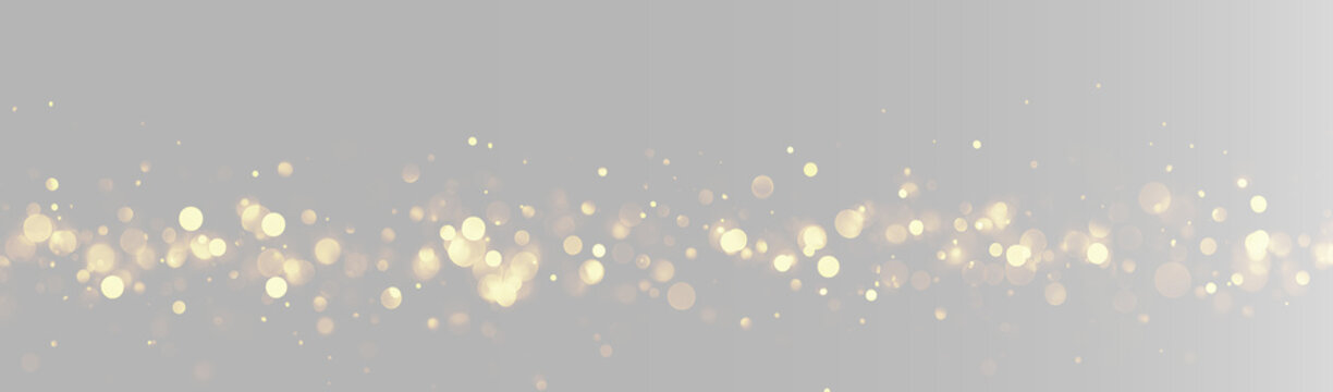 Abstract gold glitter horizontal line on grey background, glowing golden particles border