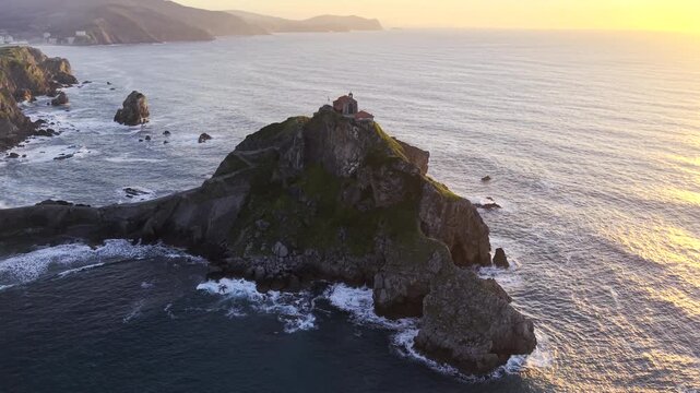 San Juan de Gaztelugatxe, Spain HDR drone video. Aerial view of the lonely hermitage perched atop a towering rocky islet above the ocean off the coast of Basque Country in northern Spain. 

