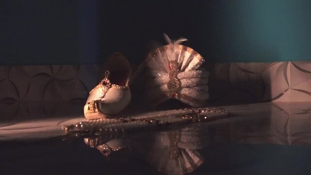 Traditional Groom shoes and Turban with Pearl Jewelry on Dark Background