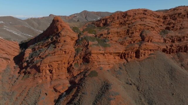 Aerial footage of the Seven Bulls red sandstone rock formation in Jety Oguz Gorge near Karakol, Issyk-Kul Region, Kyrgyzstan, in clear summer daylight