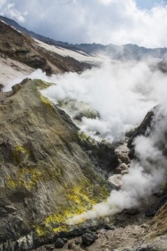 Smoking fumaroles with sulphur depositions on Mutnovsky volcano, Kamchatka, Russia