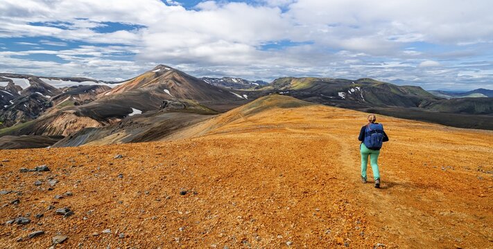 Hiker on the Laugavegur trekking trail, Laugavegur trekking trail, Dramatic volcanic landscape, Colourful erosion landscape with mountains, Lava field, Landmannalaugar, Fjallabak nature reserve, Su&eth;urland, Iceland