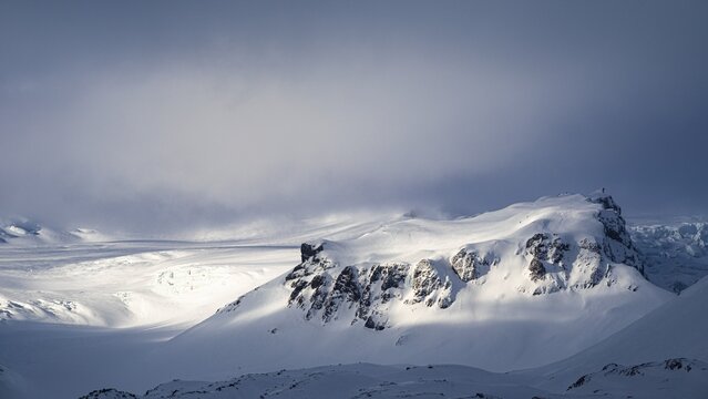 Fog, light and shadow on the snowy summit of Breidamerkurfjall, Sudurland, Iceland