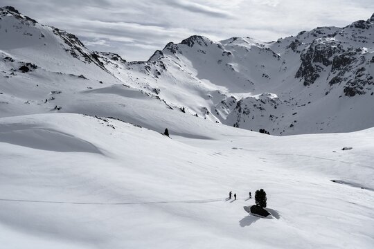 Ski tourers cross a flat slope, Wattentaler Lizum, Tuxer Alps, Tyrol, Austria