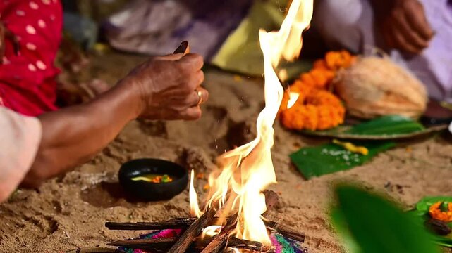 Close-up footage of a sacred Havan fire (Agni Kund) burning during a traditional Hindu wedding ceremony in India. The holy fire serves as a divine witness to the marriage and symbolizes purity.