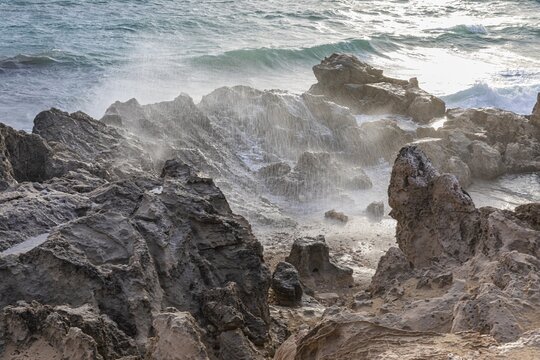Sea water lashes over the eroded rocks on Salines beach, Ibiza, Balearic Islands, Mediterranean Sea, Spain