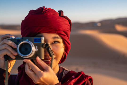female photographer with rangefinder camera in the Sahara