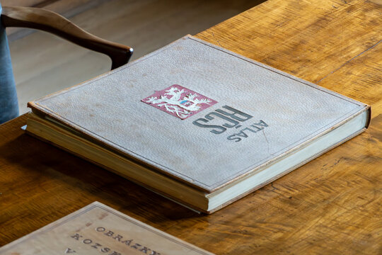 Atlas of the Czechoslovak Republic lies on the table. Old map atlas with detailed maps.