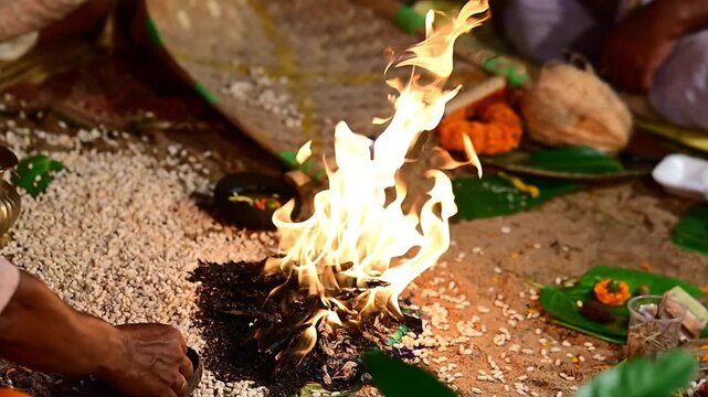 Close-up footage of a sacred Havan fire (Agni Kund) burning during a traditional Hindu wedding ceremony in India. The holy fire serves as a divine witness to the marriage and symbolizes purity.