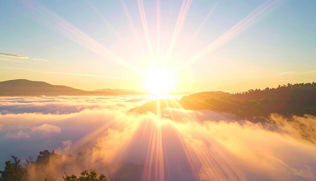 Sunbeams pierce through clouds over a misty mountain landscape at sunrise.