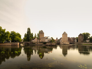 Obraz premium Ponts Couverts towers reflected in calm waters of Strasbourg France