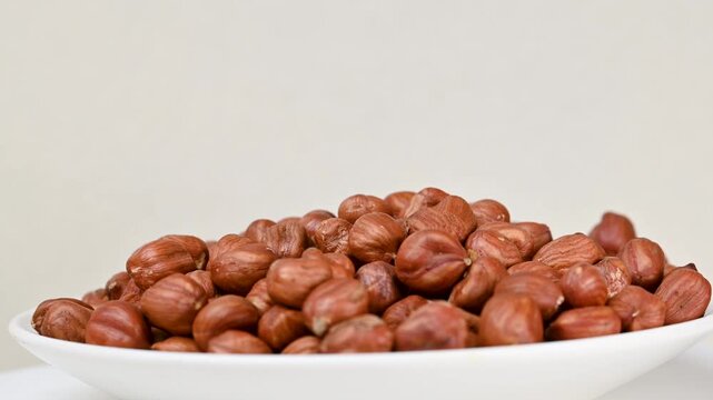 Hazelnuts heap rotating. Organic snack. Pile of hazelnuts without shell. Vegan food. Top view. Healthy nutrition. Energy product. Peeled nut.