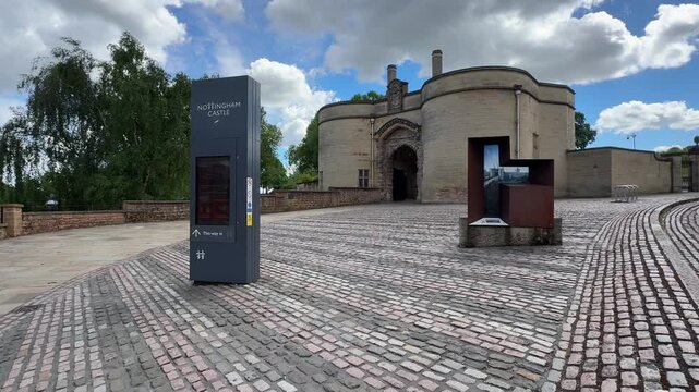 Entrance view of Nottingham Castle near Old Market Square and Robin Hood statue in Nottingham, East Midlands, England, showcasing historic architecture.