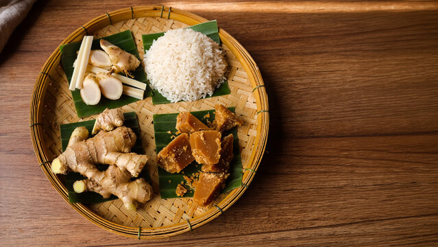 Part of Nusantara Harvest, Ingredients for Indonesian jamu on bamboo tray rice ginger palm sugar