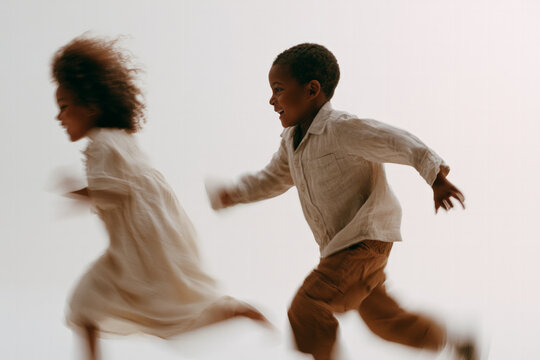 Joyful children running and playing in soft light outdoors