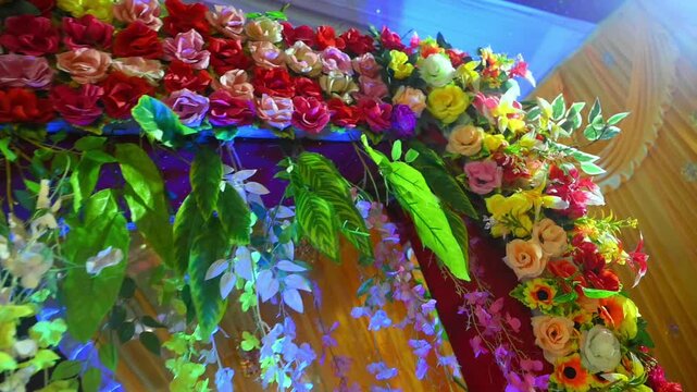 The vibrant floral setup represents traditional Indian wedding celebrations, marriage ceremonies, reception events, cultural festivities, event planning, luxury decoration, and romantic occasions.