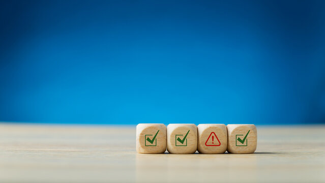 Problem and error warning concept. Wooden cubes with triangle caution warning sign, warning system for notification error and maintenance. Incident, risk, contingency management. Proactive approach.