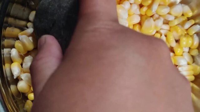 Adding chopped scallions to sweet corn kernels for corn fritter recipe