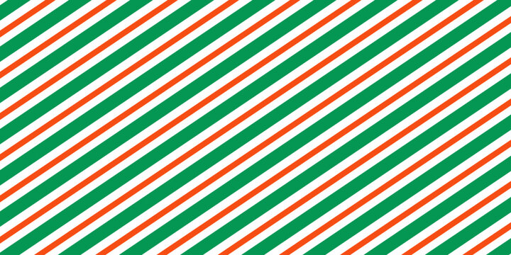 Christmas seamless pattern. Red and green diagonal stripes background. Candy cane repeating decoration wallpaper. Winter holiday lines backdrop. Xmas peppermint present wrapping print design. Vector