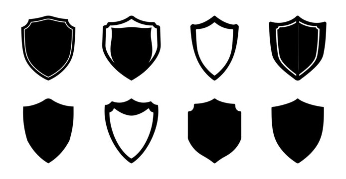 Set of eight black shields with different designs - Eight stylish black shields in varied shapes and decorative elements, perfect for icons or badges.