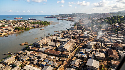 Old town Freetown Sierra Leone. Coast of west Africa. Flying over slums in factory area beside the river. © pinan