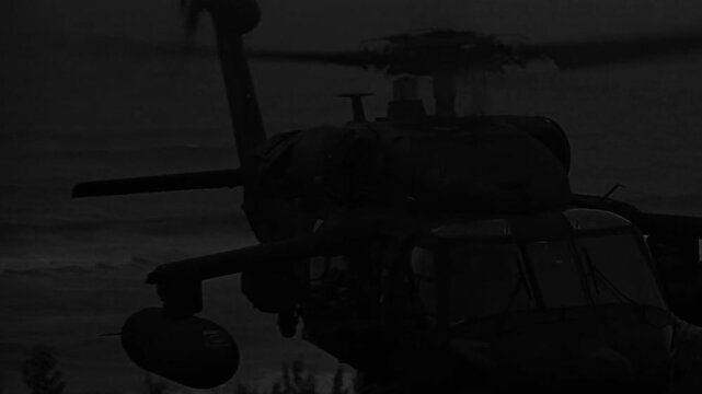 Helicopter flying slowly above ocean,  close shot