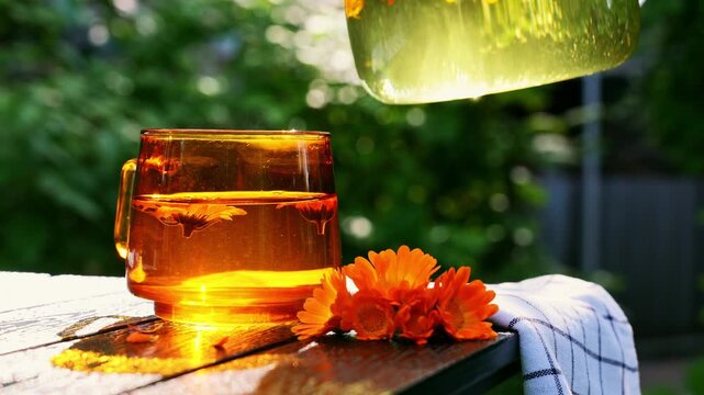 Homegrown calendula detox tea poured into glass mug