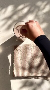Morning cacao milk drink being stirred in sunlight at breakfast
