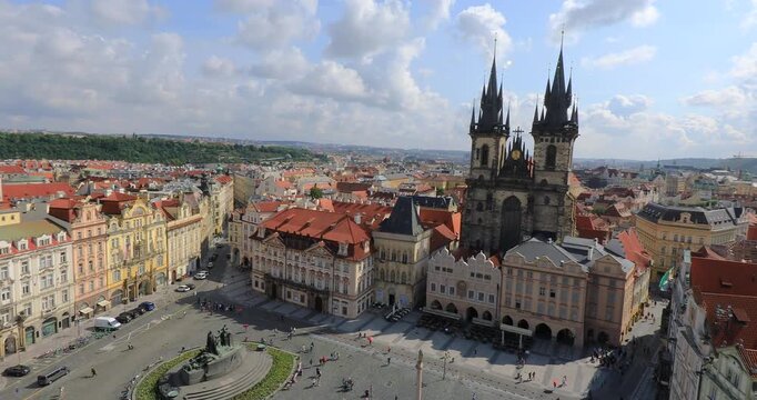 4K panning right motion High angle view of the Jan Hus Monument and the Tyn Church in background at the old town square in the city of Prague, Czech Republic, Europe