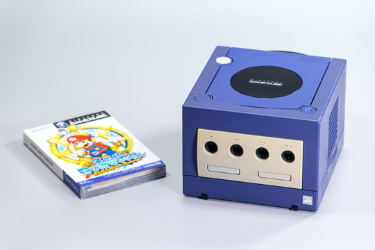Fukuoka, Japan. June 6, 2026: Indigo Nintendo GameCube console displayed with a Super Mario Sunshine game case in a clean studio product photograph.
